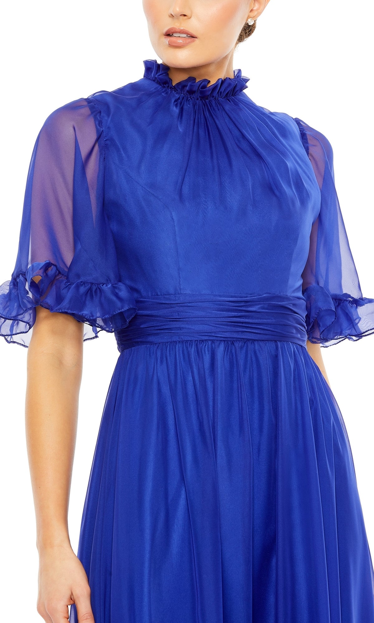 A woman wears the Mac Duggal 68229, a royal blue long formal A-line dress featuring sheer ruffled short sleeves, a high ruffled neckline, and a fitted waistband.